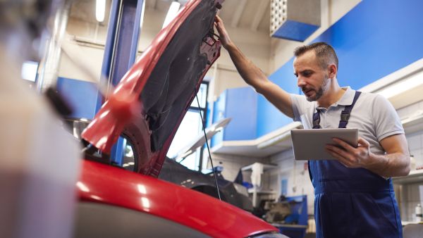 Mecânico fazendo manutenção preventiva do carro na oficina